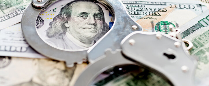hundred dollar bills and handcuffs