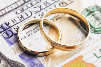 money and wedding rings representing high asset divorce in midland texas