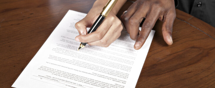 A couple signs a prenuptial agreement