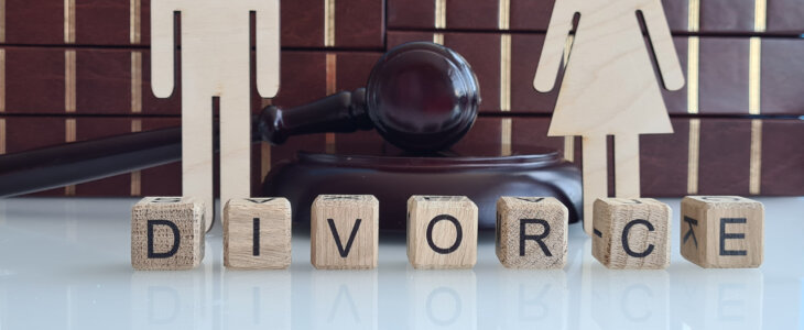 shows a white surface with wooden blocks spelling out the word DIVORCE