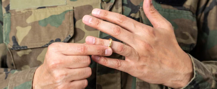 a military man taking off their ring because they are goring through a miliary divorce in midland and odessa texas