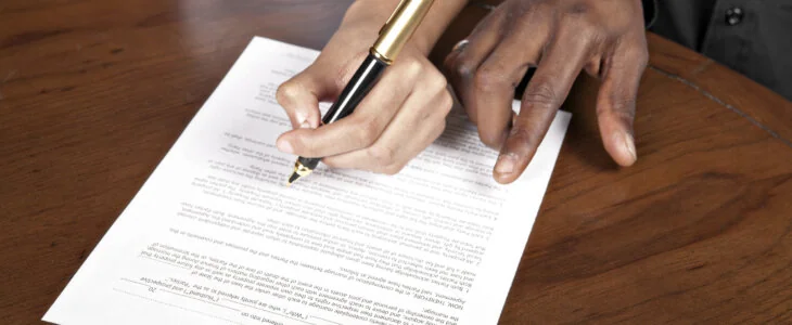 A couple signs a prenuptial agreement