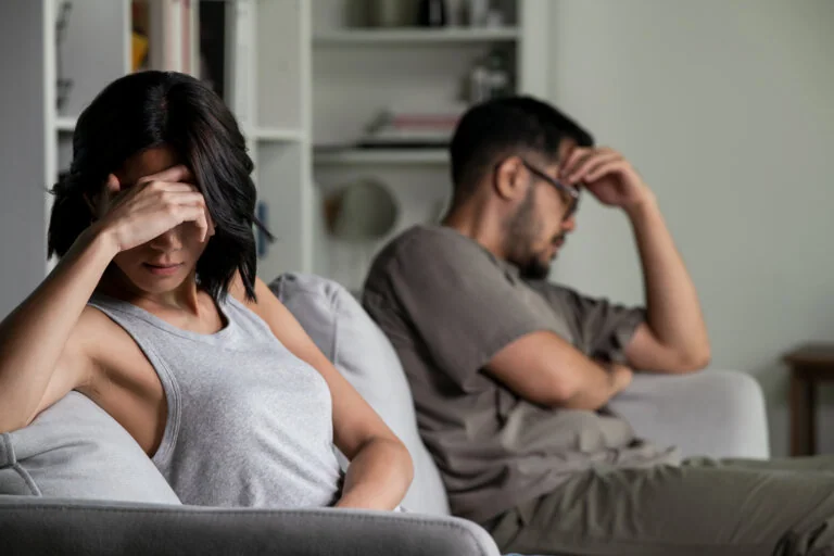 Young Asian married couple after a fight, Angry couple ignoring each other, relationship troubles.
